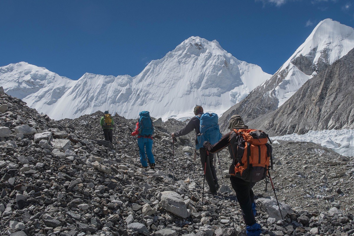 4 người trong đoàn leo núi di chuyển qua đoạn đường sỏi đá lên đỉnh Cho Oyu